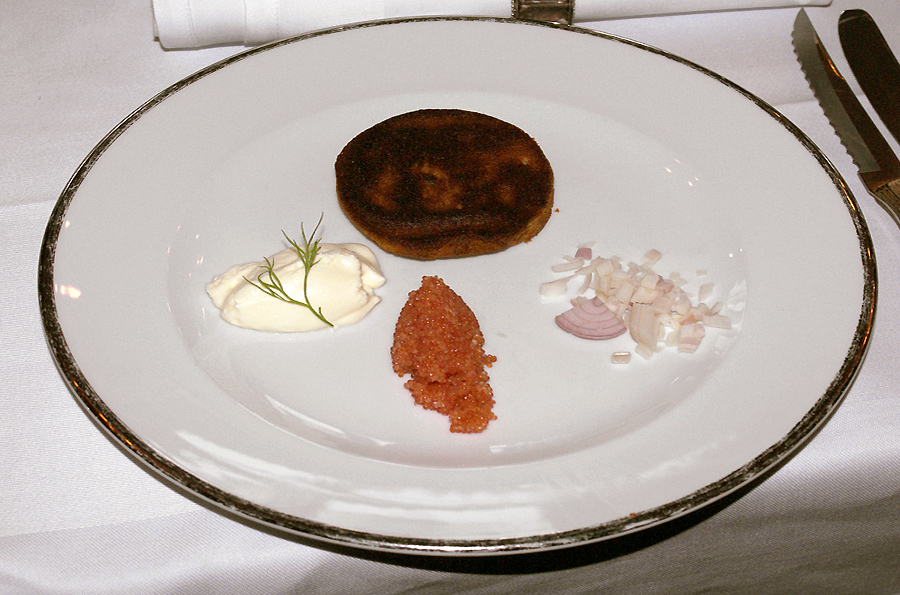 Blini served with caviar and onions.